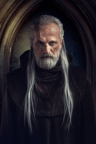 istock Medieval wizard with long white hair in cloak 2233363055
