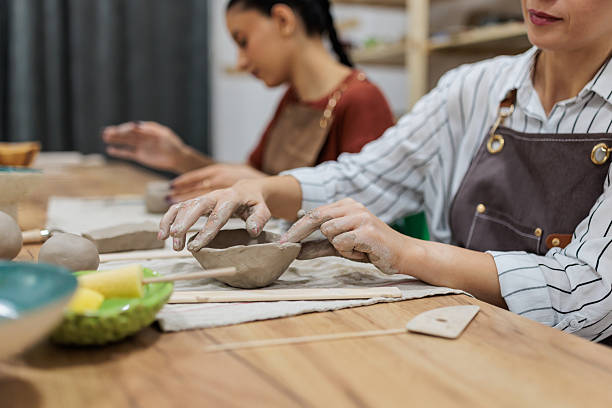 istock Woman molding clay in pottery class 2233365810
