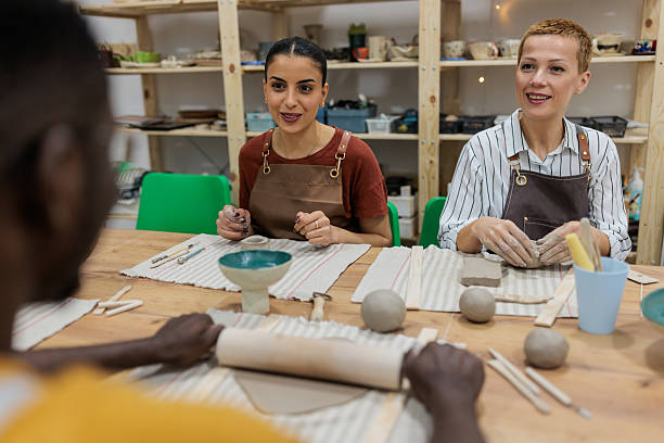 istock Three friends enjoying pottery class together 2233366052