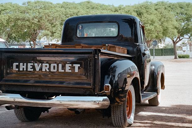 Calafell, Spain – May 31, 2025: Rear view of a classic black 1954 Chevrolet 3100 Advance Design pickup truck, captured on 35mm film at a car show, showing a vintage style