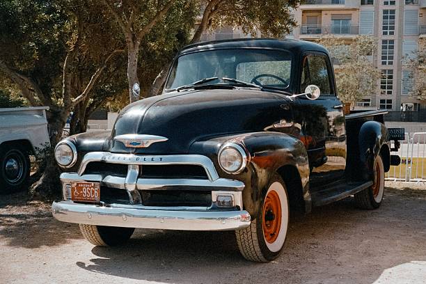 Calafell, Spain – May 31, 2025: A classic black 1954 Chevrolet 3100 Advance Design pickup truck, captured on 35mm film at a car show, showing a vintage style and beautiful analog