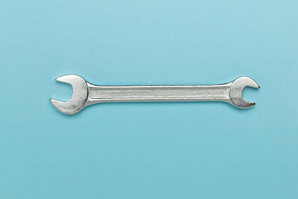 istock Minimalist Silver Wrench on Blue Background: Industrial Tool Aesthetic for Modern Design 2233367325