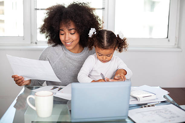 istock Young mother working and spending time with her daughter 2233367788