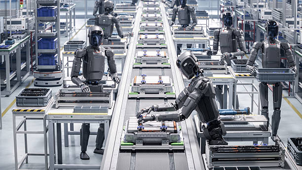 istock 3D Render: Industrial Automation AI Accelerated: Advanced Human Like Robots Working on Complex Detail in Industrial Environment. Autonomous AI Powered Humanoid Robot Works at Factory on Assembly Line. 2233368693
