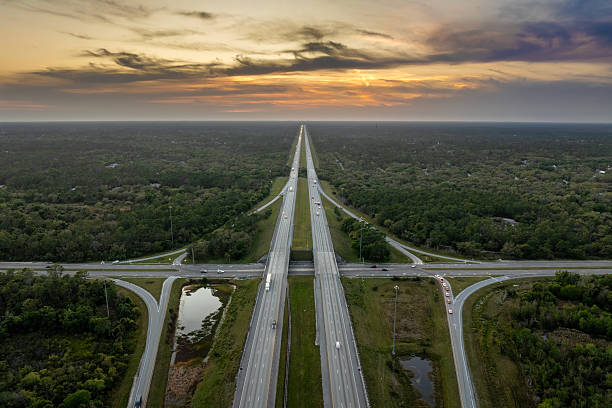 istock American highway bridge with fast moving traffic in evening. Interstate transportation concept 2233370253
