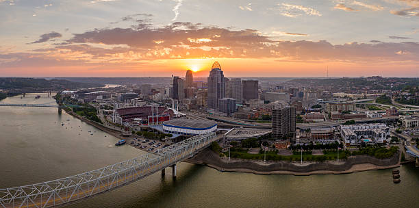 istock Highway traffic on bridge in Cincinnati, Ohio with brightly illuminated high skyscraper buildings in downtown district. American city with business financial district at sunset 2233370275