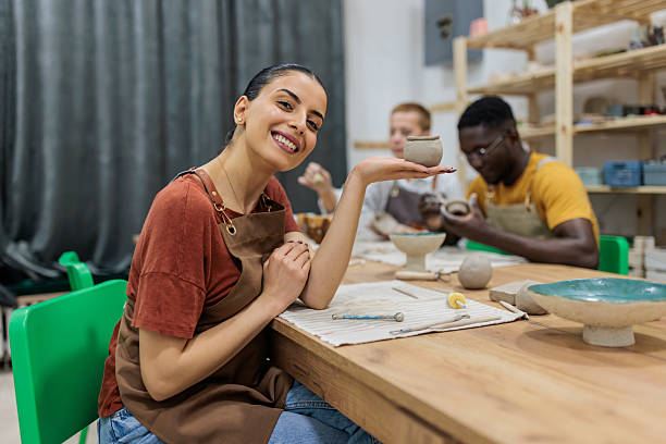 istock Smiling woman with handmade clay piece 2233371170