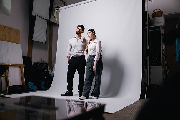 Two young professionals stand together, exuding confidence and teamwork in a modern business portrait