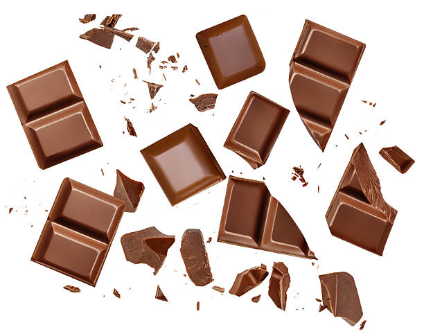 istock Broken chocolate bar pieces isolated on white. Chocolate Explosion with scattered  cocoa crumbs .Top view. Flat lay. Pattern  2233373104