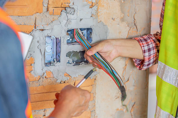 istock inspector hand checking electric wire with electrician at a new building under construction 2233373167