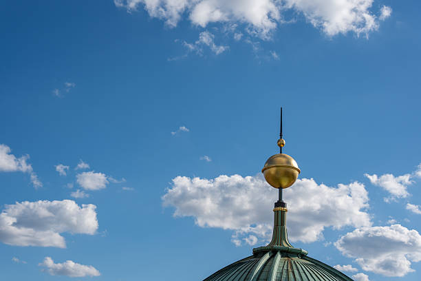 istock A green dome with a golden sphere and spire rises into the sky. 2233374274