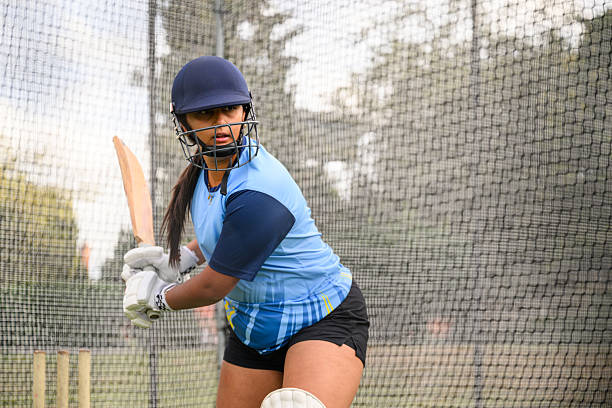 istock Candid portrait female batsman in nets ready to take a shot 2233374375