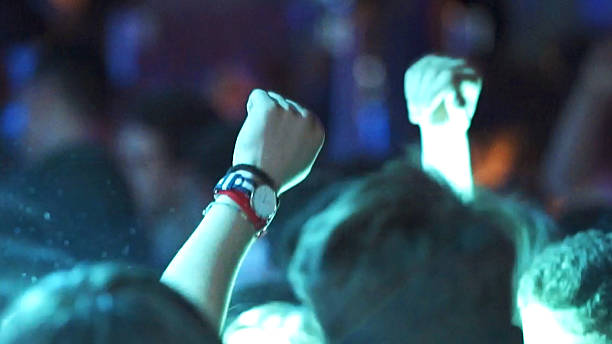 istock crowd hands up at concert, people's hands raised dancing 2233374839