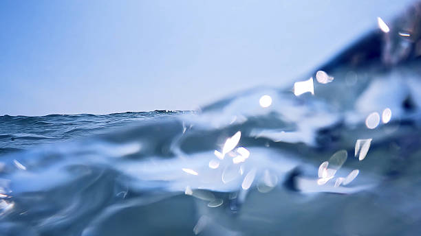 istock close up view of waves on water surface. Bright waters 2233375043