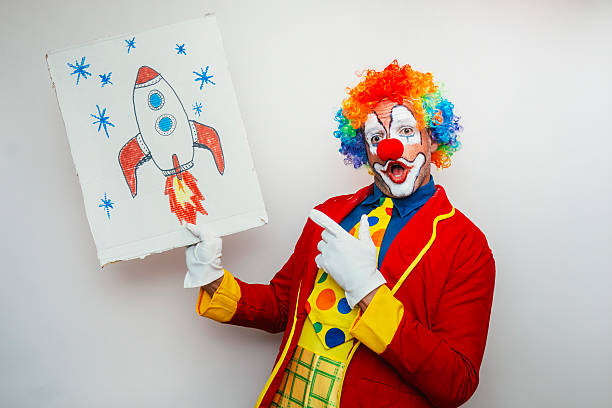 Old-aged Clown with book,studio,white background