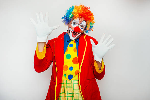 istock Clown raising hands in comic surprise 2233375088