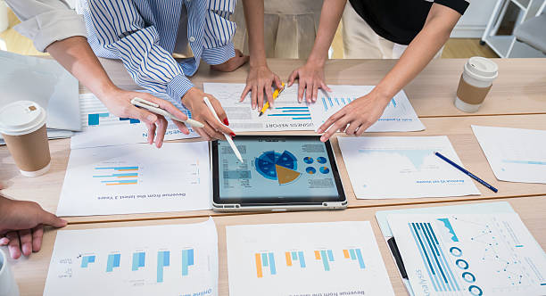 istock Group of professionals analyzing data charts during a business meeting in a modern office, collaborating on strategies and reviewing financial or project performance. 2233376045