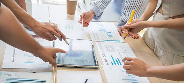 istock Business team in office meeting working with documents and laptops on table, brainstorming creative ideas and planning strategies for a new business venture. 2233376046