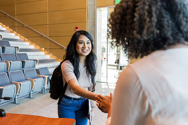 istock Smiling young woman shaking hands, university student 2233376504