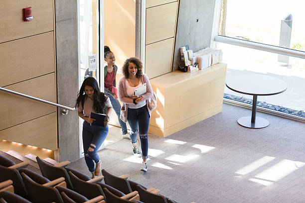 istock Confident female students walking together in a university building 2233376512