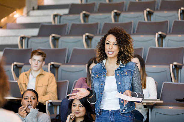 istock Young Woman Giving Presentation to Diverse Classmates 2233376609
