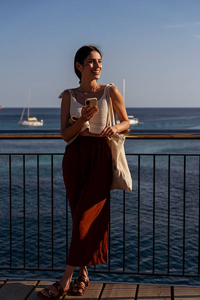 istock Woman on vacation with smartphone 2233377582