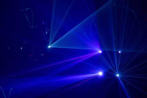 istock Blue and purple beams in dark background. 2233379673