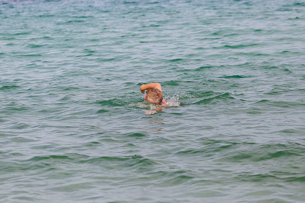 man enjoy recreational crawl swim in the sea