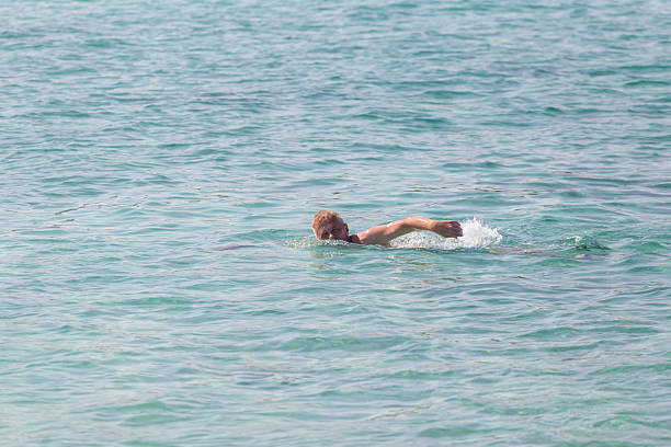 man enjoy recreational crawl swim in the sea