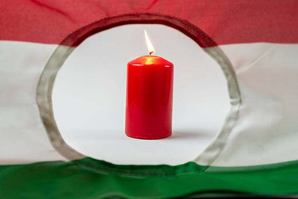 istock Hungarian revolution flag and burning candle 2233383465