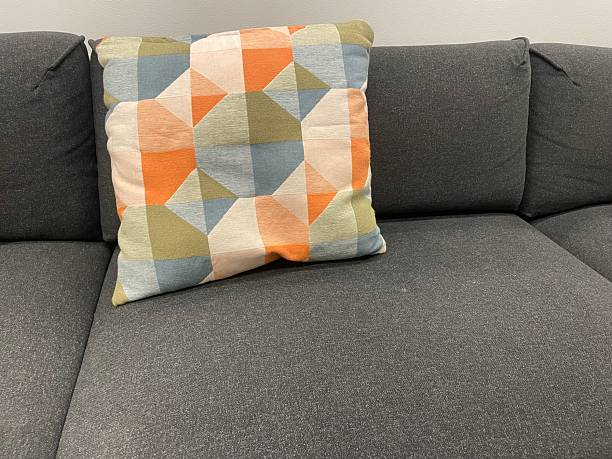 istock Decorative Throw Pillows on Dark Gray Sofa – Textured Blue and Geometric Pattern 2233386262