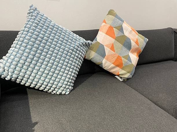 istock Decorative Throw Pillows on Dark Gray Sofa – Textured Blue and Geometric Pattern 2233386302