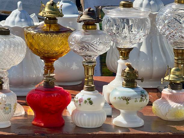 Vintage and antique glass oil lamps for sale at a outdoor flea market