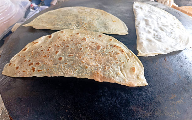 istock Preparing traditional Turkish Gozleme on hot griddle 2233390572