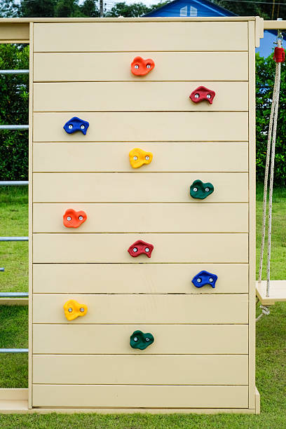 istock Wooden playground with rock climbing simulator in the park 2233390631