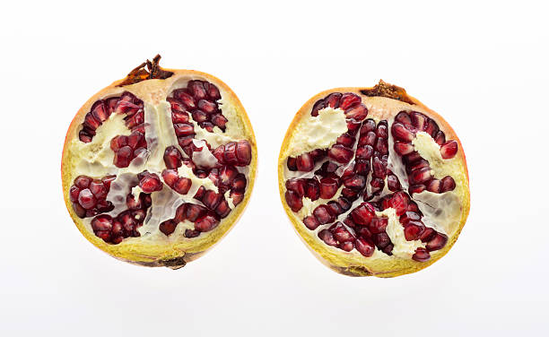 Two half pomegranates on white background