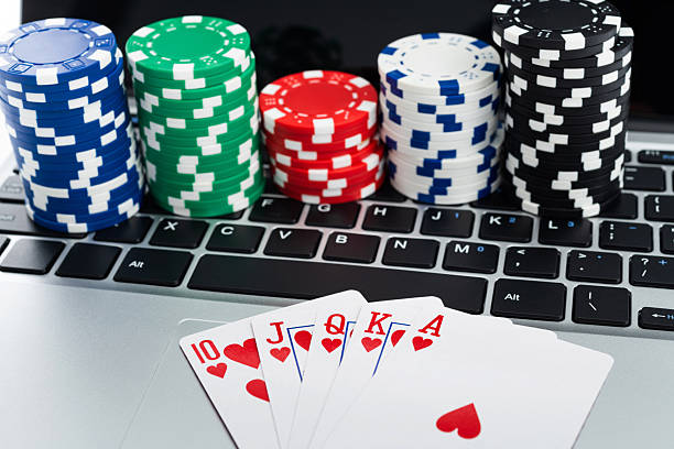 istock Gambling chis and playing card on laptop keyboard 2233391679