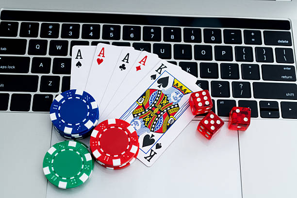 istock Gambling chips and playing card on laptop keyboard 2233391686