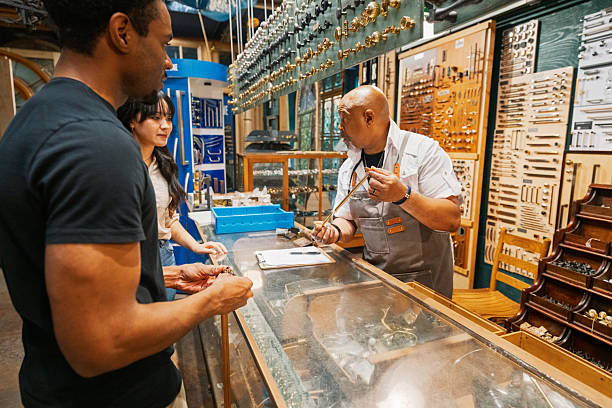 istock Professional Craftsman Explaining Hardware Options to a Cheerful Young Black Man and Asian Woman Shopping for Interior Design or Reclaimed Items in an Antique Restoration Shop 2233396888