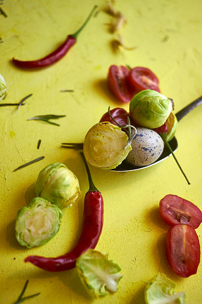 Stock photo showing close-up, elevated view of freshly steamed and peeled Brussel sprouts in a metal steamer pan.