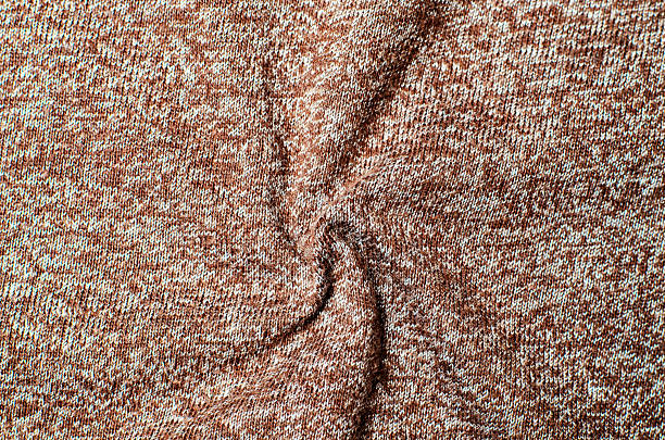 istock Brown and white cotton fabric twisted into spiral shape creating soft textile background for modern fashion design and decorative interior concepts 2233402634