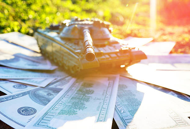 istock Battle tank on US dollar banknotes. 2233405192