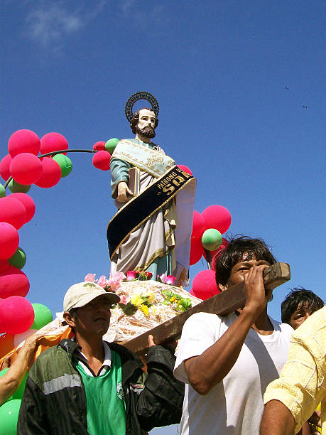 General Villamil Playas, Guayas, Ecuador - January 15, 2006: Group of devotees carrying a statue of Saint Peter, patron saint of fishermen, during a vibrant street procession in General Villamil Playas, Ecuador, celebrating their faith and cultural heritage