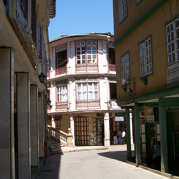 Zaruma, El Oro, Ecuador - August 10, 2007: Traditional architecture shines in Zaruma, Ecuador, with colonial-era buildings lining a picturesque street, bathed in sunlight and showcasing the town's rich history