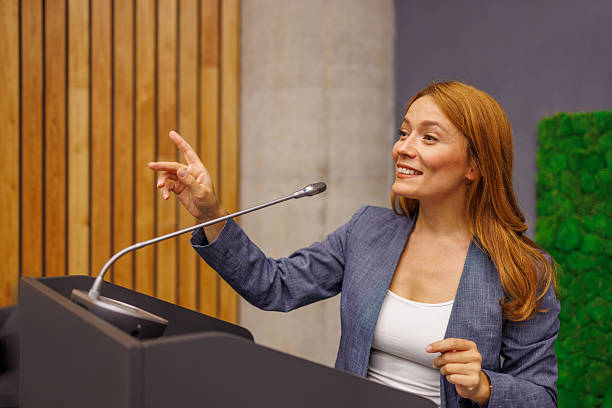istock Businesswoman giving a speech at a conference 2233407484