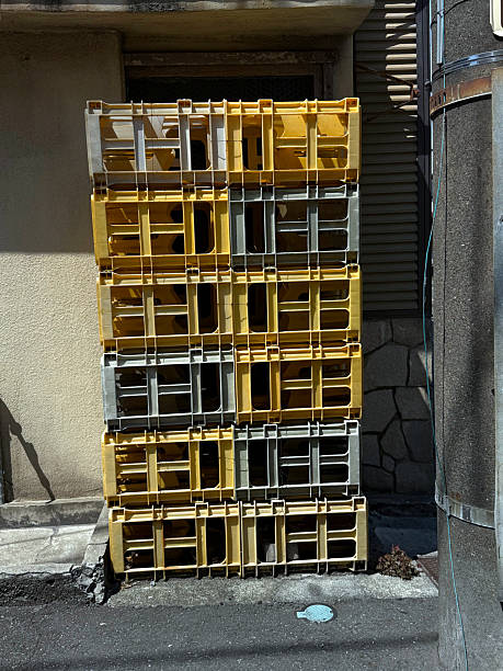 istock Plastic crates stacked against a wall. Urban life concept. Handheld mobile photo, selective focus, harsh sunlight, non AI 2233410006