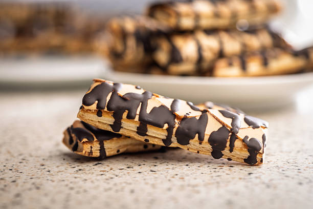 istock Sfogliatine glassate with chocolate. Italian crispy dessert on kitchen table. 2233410502