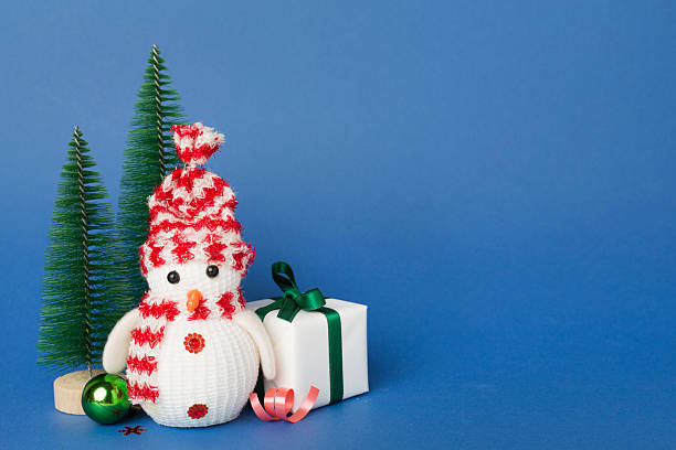istock Small christmas trees with decoration on color background 2233410768