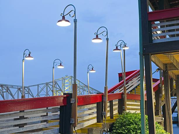 istock Illuminated elevated boardwalk rising to a business establishment 2233411475