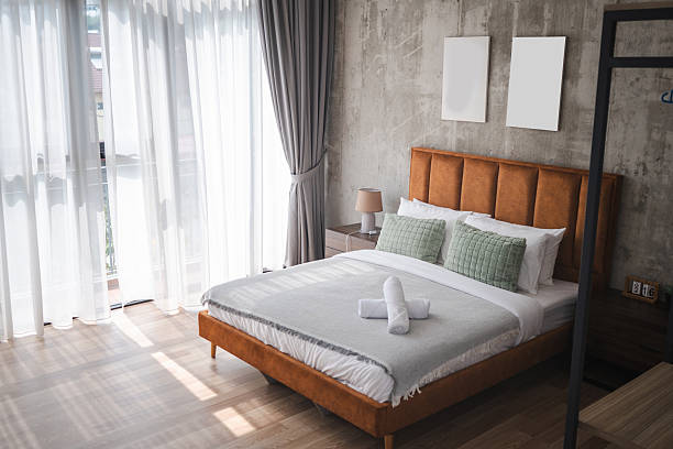 istock Spacious City-View Bedroom with a Comfortable Double Bed and Fresh Linens 2233411805